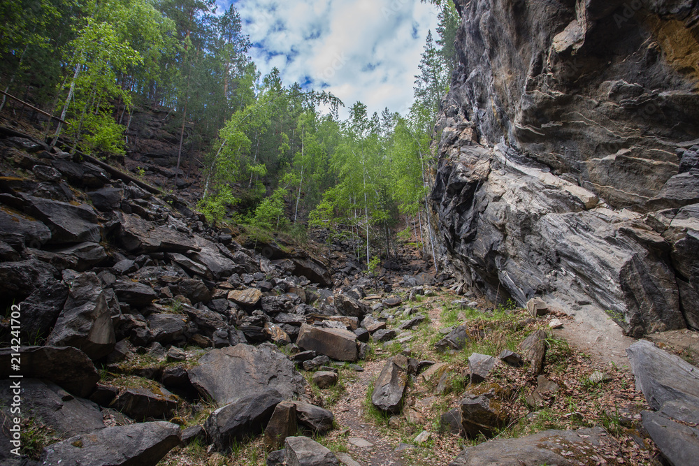 Obraz premium Abandoned ore mica mine quarry open pit in forest