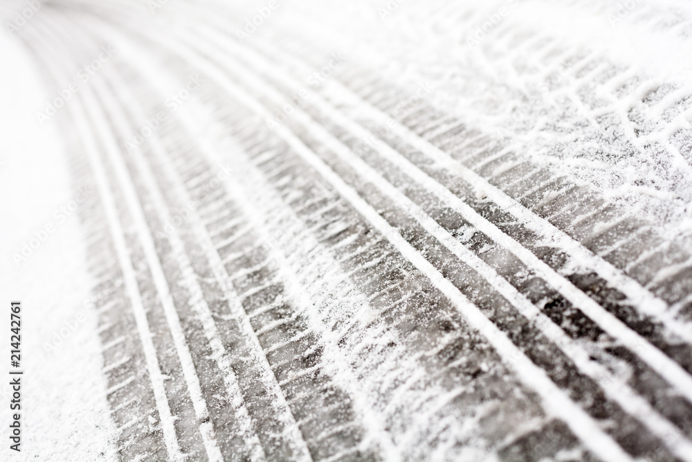 Wheel tracks on the road covered with snow