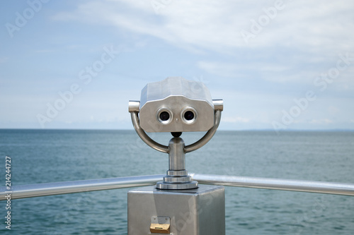 Binoculars, view of the sea and clouds