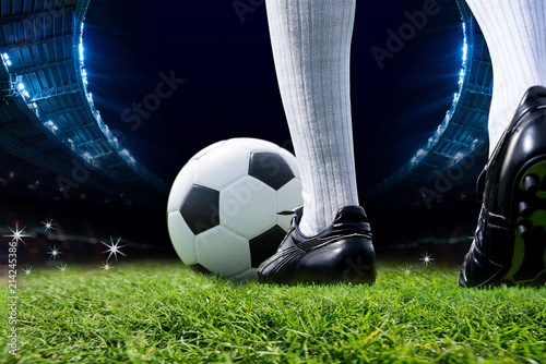 Foots Of Soccer Player Or Football Player Walk On Green Grass To Play Match With Soccer Ball and Stadium Backgrounds. © pongsakorn_jun26