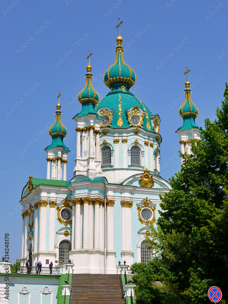 Beautiful massive church with green gilt domes on a clear blue sky background Beautiful massive church with green gilt domes on a clear blue sky background