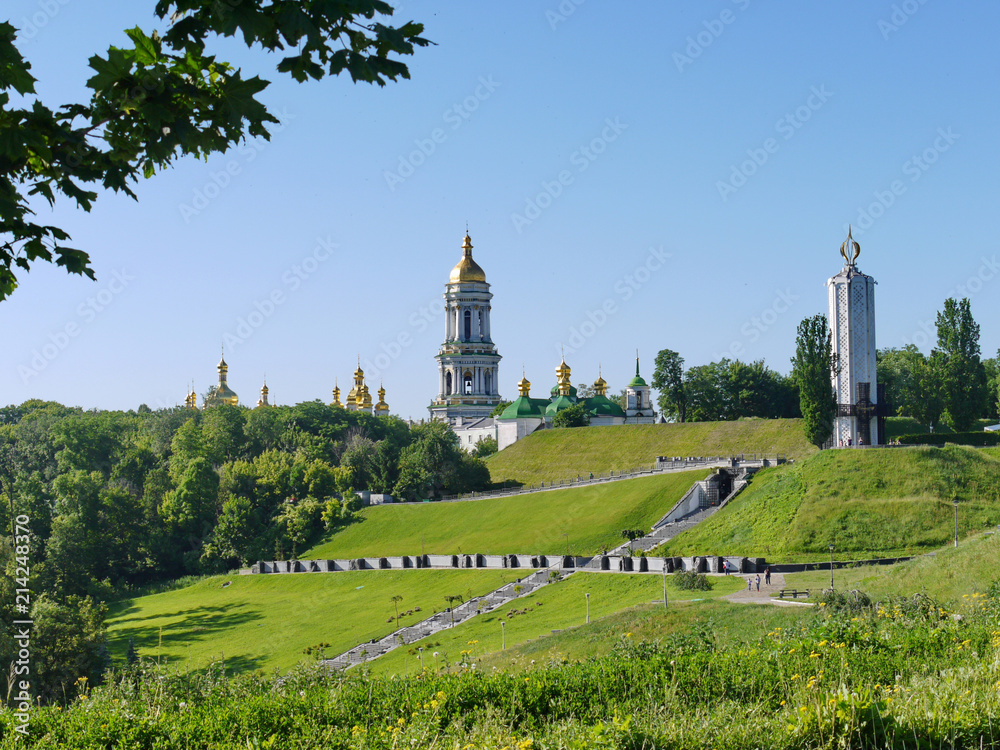 A large park area with stone steps and walking alleys against the backdrop of golden-domed churches