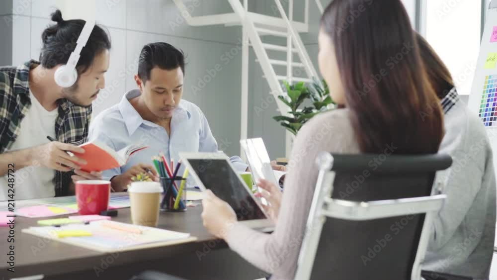 Group of casually dressed businesspeople discussing ideas in the office. Creative professionals gathered at the meeting table for discuss the important issues of the new successful startup project. Group of casually dressed businesspeople discussing ideas in the office. Creative professionals gathered at the meeting table for discuss the important issues of the new successful startup project.