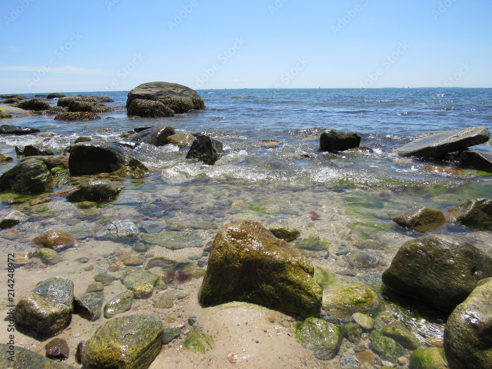 A beautiful rocky beach on a sunny day with blue sky A beautiful rocky beach on a sunny day with blue sky