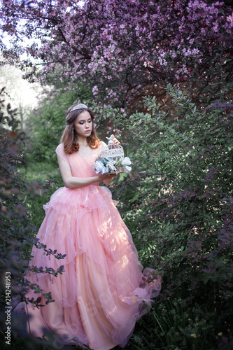 girl in a pink dress in a flower garden