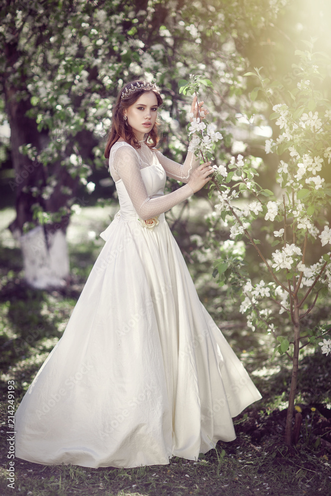 Beautiful young bride in a blooming garden