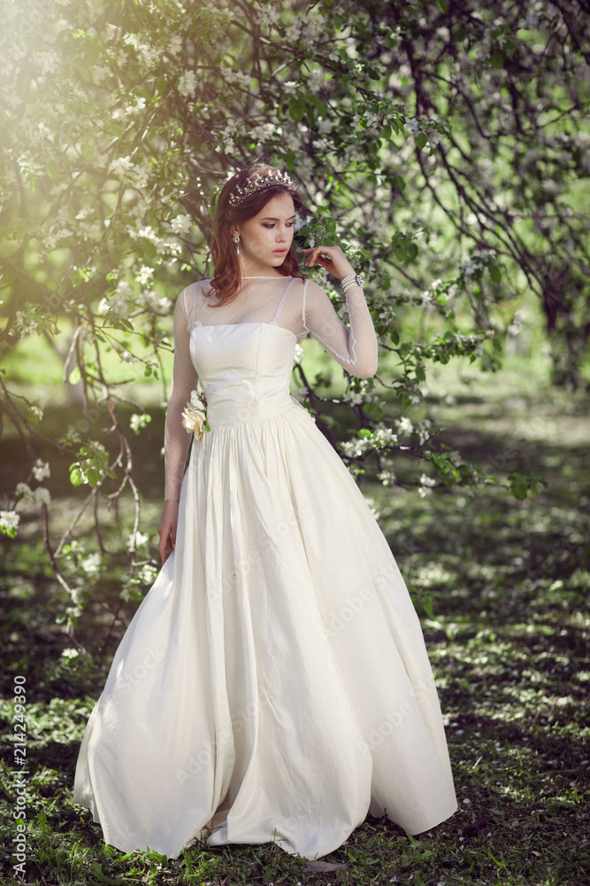 Beautiful young bride in a blooming garden