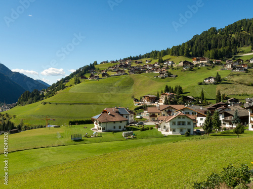 Beautiful view of idyllic mountain scenery in the Dolomites with mountain village , Val di Funes, South Tyrol, Italy photo