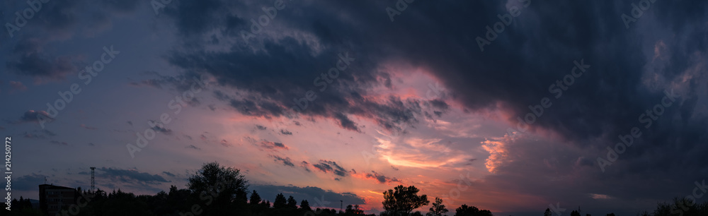 Dark sky panorama with colorful sunset clouds