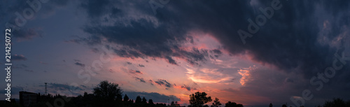 Dark sky panorama with colorful sunset clouds