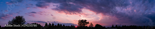 Dark sky panorama with violet sunset clouds
