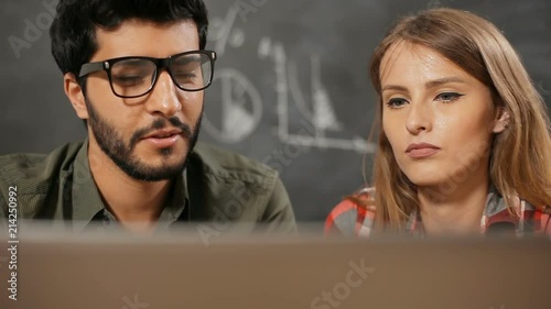 Two intelligent managers discussing the project, trying to find a solution together with the help of computer program, concept of cooperation and teamwork