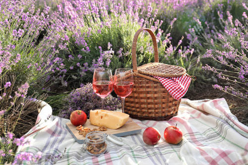 Fototapeta Naklejka Na Ścianę i Meble -  Set for picnic on blanket in lavender field