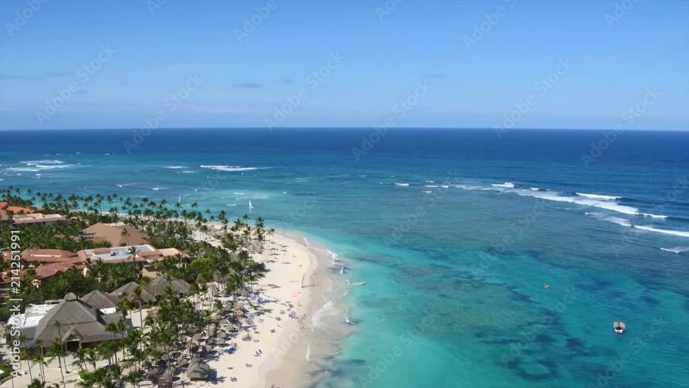 Summer Dominican Republic beach, exotic palm trees, white sand, white sand beach / The island of Hispaniola, Punta Cana beaches. Sun umbrellas, chaise lounges, on the beach. Summer Dominican Republic beach, exotic palm trees, white sand, white sand beach / The island of Hispaniola, Punta Cana beaches. Sun umbrellas, chaise lounges, on the beach.