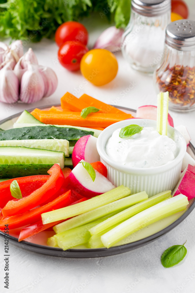 Vegetable sticks of cucumber, pepper, carrots, celery and radishes with white sauce of sour cream, yogurt, herbs.