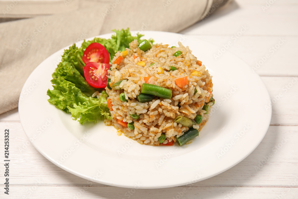 Plate with tasty boiled rice and vegetables on table Plate with tasty boiled rice and vegetables on table
