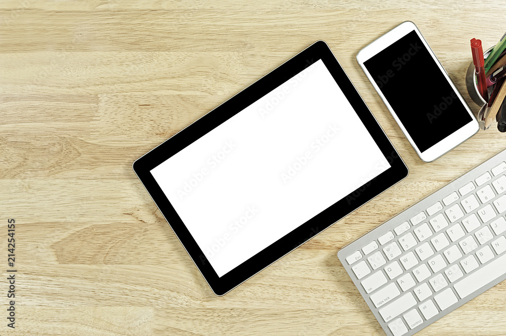 blank screen smartphones and tablet PC on the wooden desktop with computer keyboard and a cup of coffee in composition with copy space for your text blank screen smartphones and tablet PC on the wooden desktop with computer keyboard and a cup of coffee in composition with copy space for your text