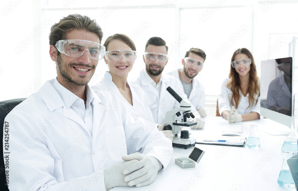 Male scientist and the team in the lab. Male scientist and the team in the lab.