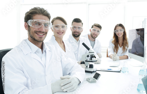 Male scientist and the team in the lab.