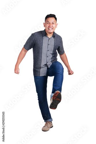 Photo image portrait of a young Asian male student stepping forward, side view, isolated on white © airdone