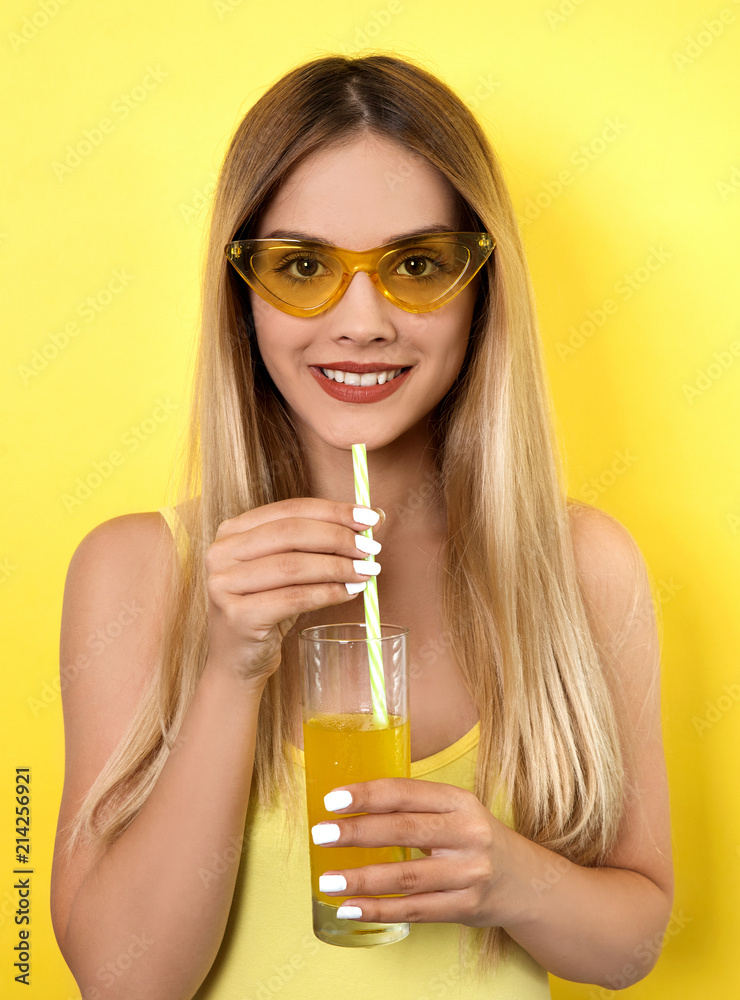 Young woman drinking juice studio shoot Young woman drinking juice studio shoot