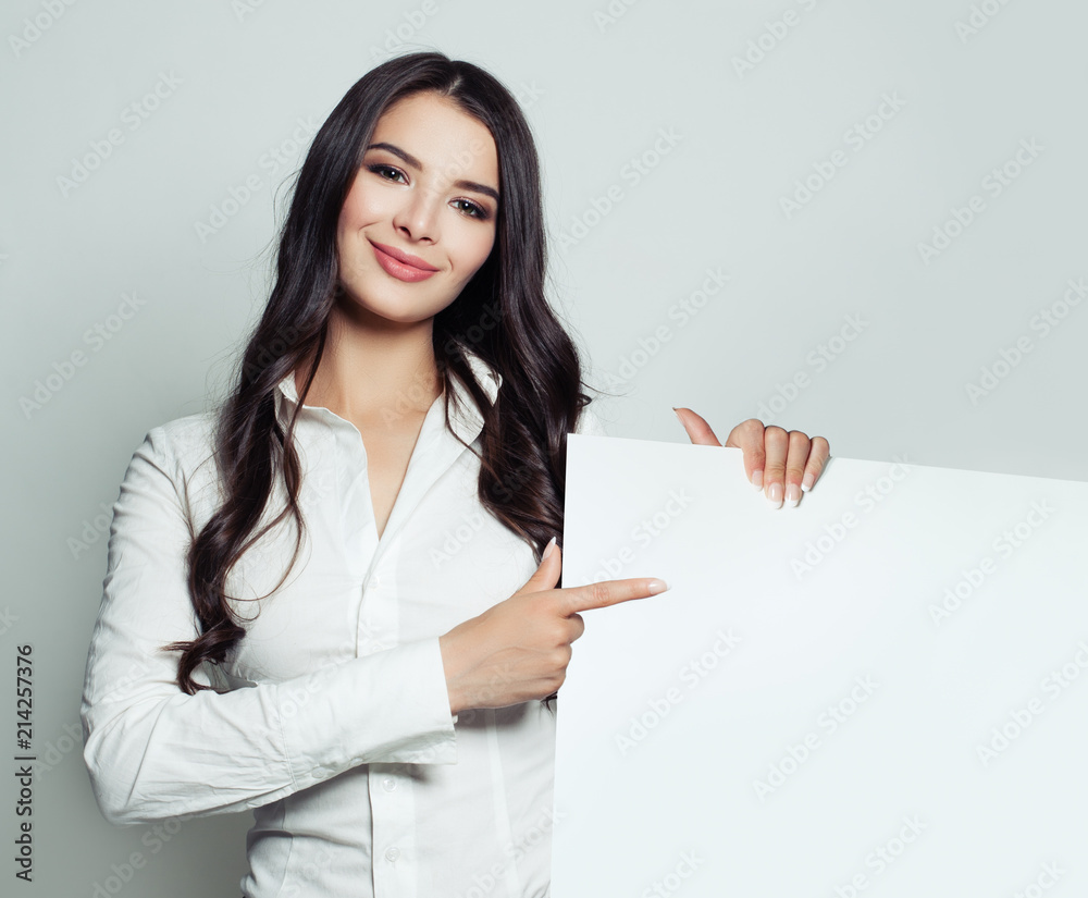 Happy young woman student with white board background with copy space in hands. Student girl portrait, business, start up and education concept Happy young woman student with white board background with copy space in hands. Student girl portrait, business, start up and education concept