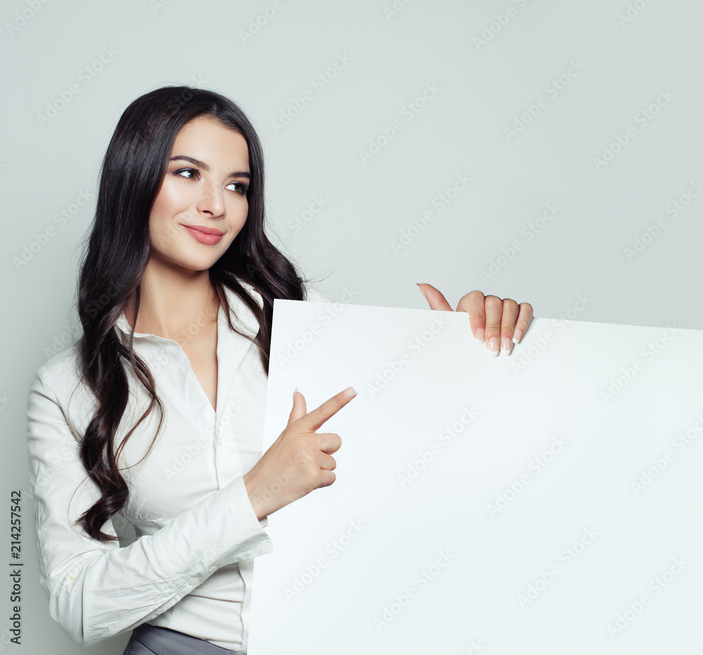 Confident business woman smiling and showing white empty board background with copy space for advertising marketing or product placement. Successful business lady portrait Confident business woman smiling and showing white empty board background with copy space for advertising marketing or product placement. Successful business lady portrait