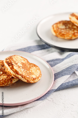 Cottage cheese pancakes, syrniki, curd fritters. Breakfast on white background.