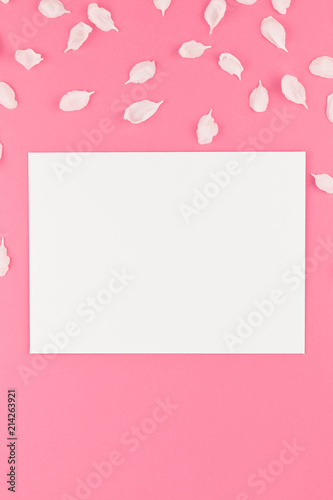 Flat lay of white postcard mock up with petals © dvoevnore