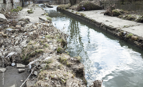 Garbage on the urban stream banks photo