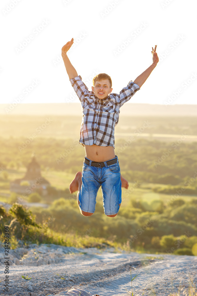 happy guy jumping to the top on the background of nature and sun concept of success and happiness happy guy jumping to the top on the background of nature and sun concept of success and happiness