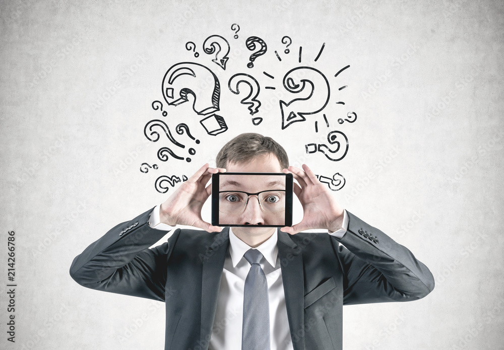 Businessman face zoom in tablet, question marks Businessman face zoom in tablet, question marks