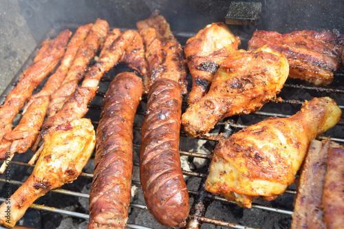 sausages, shish kebabs chicken and bacon baked on the grill