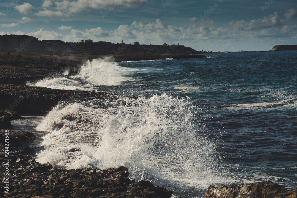 Sea wave splashing on rocks, natural holiday vintage hipster seasonal background