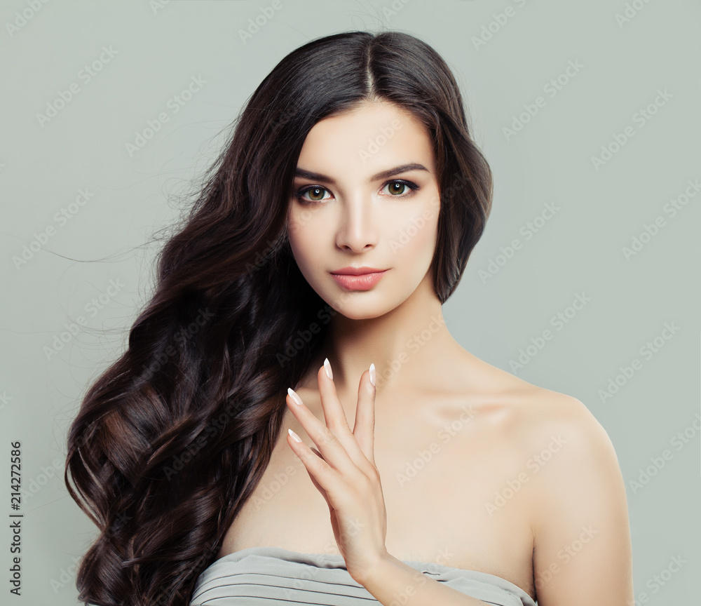 Naklejka premium Young Beautiful Woman with Healthy Wavy Hairstyle, Natural Makeup and Fresh Skin, Hair careand Facial Treatment.