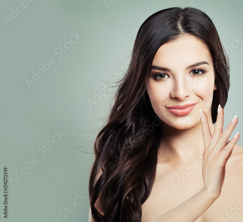 Beautiful Woman with Fresh Skin and Healthy Brunette Hair. Facial treatment. Cosmetology, beauty, haircare and spa