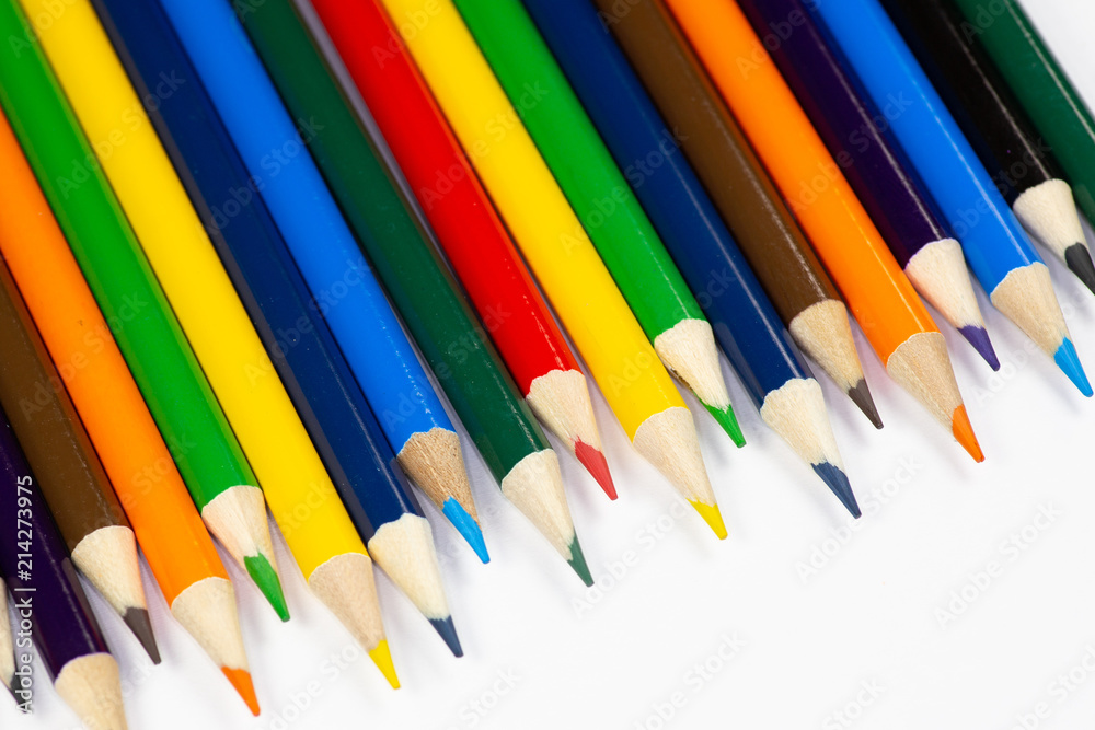 Color pencils lined up in a row against a white background.