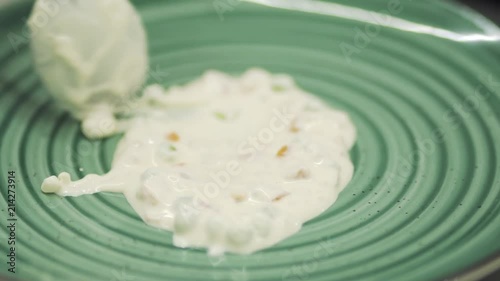 Cook decorate plate with a white sauce photo