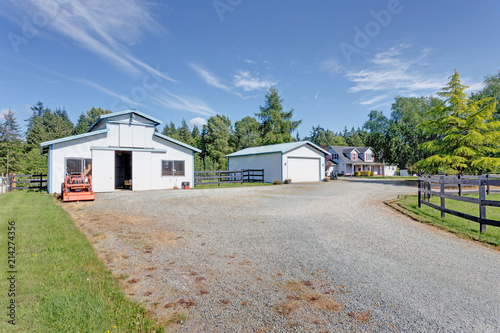 View of wide driveway to detached garages.