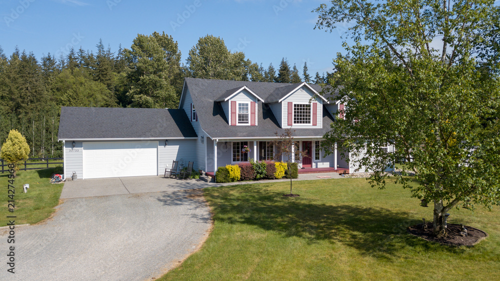 Cute home exterior with red shutters on a summer day. Cute home exterior with red shutters on a summer day.