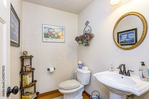 Small bathroom interior with a round pedestal sink and vintage faucet.