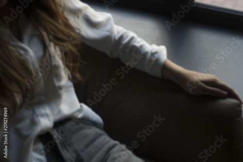 Girl sits in the armchair.