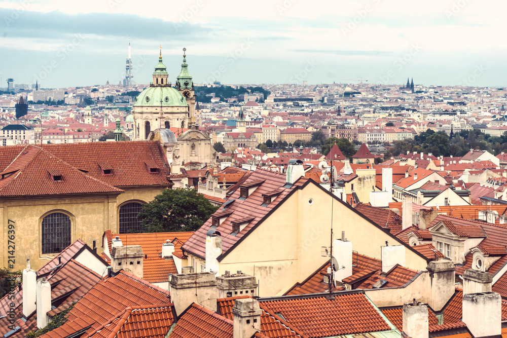 Obraz premium Beautiful views of Prague's tiled roofs and the Cathedral of St. Mikulas.