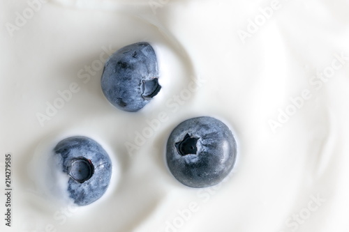 Yogurt and fresh berries blueberries, background. Flat lay, top view, copy space 
