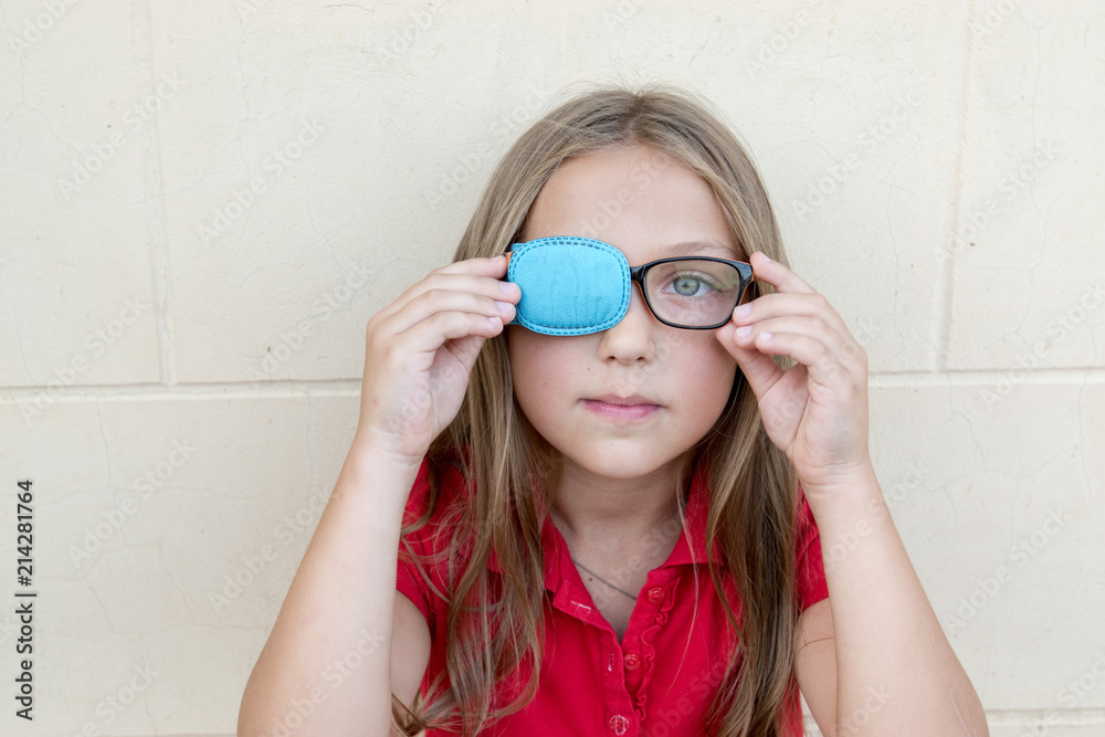 .Child in glasses with Occluder. Ortopad Girls Eye Patches nozzle for glasses for treating