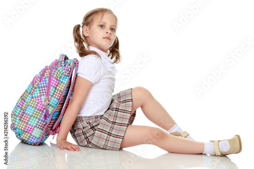 Fotografia Girl schoolgirl sitting on the floor