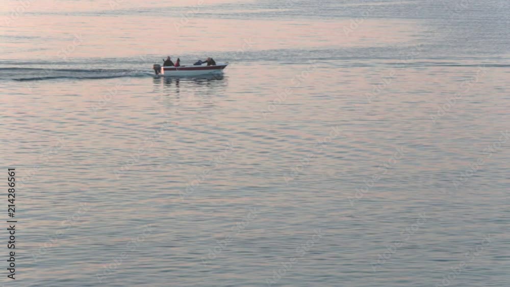 Fishing Boat With Family Floating On A Blue Sea Fishing Boat With Family Floating On A Blue Sea
