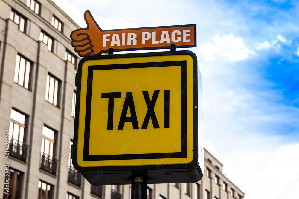 Information sign of a Taxi and Fair place on the background of houses in Prague Information sign of a Taxi and Fair place on the background of houses in Prague