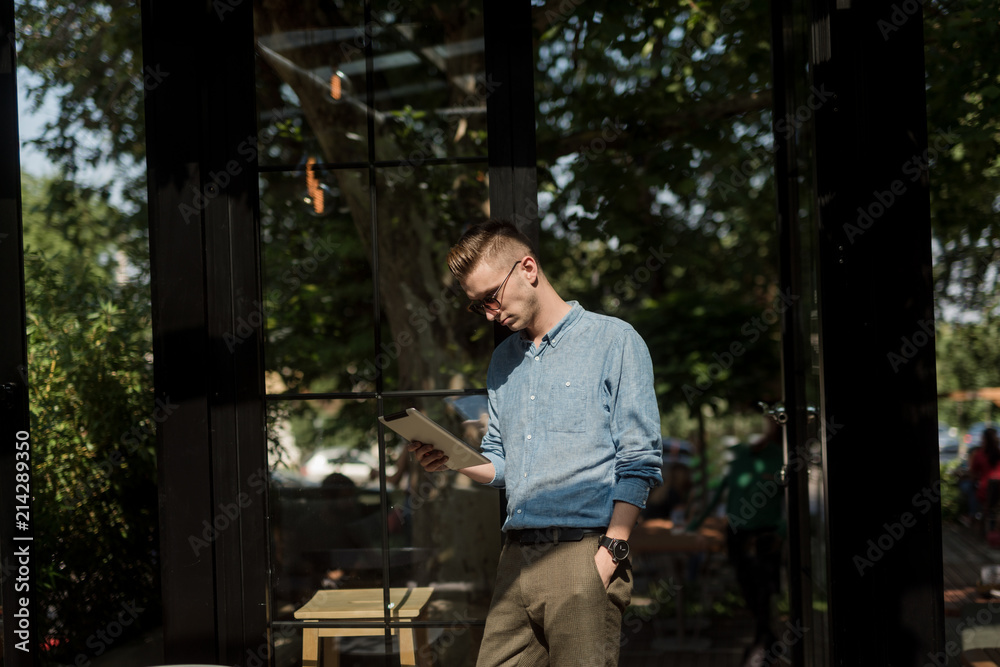 Hipster looks at the tablet Hipster looks at the tablet