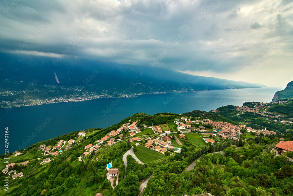 View of the Lake Garda from Tremosine, Italy.Panorama of the gorgeous Garda lake surrounded by mountains in the springtime on a cloudy day and a strong storm
